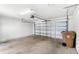Spacious garage interior with ample storage and a roll-up door at 5006 Caspian St, St Cloud, FL 34771