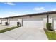 Row of white garages with driveways and landscaping, providing convenient parking at 5006 Caspian St, St Cloud, FL 34771