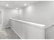 Upstairs hallway with neutral paint, carpet, and a white railing at 5006 Caspian St, St Cloud, FL 34771