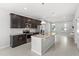 Modern kitchen features stainless steel appliances, granite countertops, dark wood cabinets, and tile backsplash at 5006 Caspian St, St Cloud, FL 34771