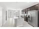 Eat-in kitchen featuring dark cabinets, stainless steel appliances, granite counters, and tile floors at 5006 Caspian St, St Cloud, FL 34771