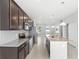 Modern kitchen features stainless steel appliances, granite countertops, dark wood cabinets, and a large island at 5006 Caspian St, St Cloud, FL 34771