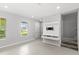 Bright, open-concept living area featuring tile flooring and modern built-in wall unit at 5006 Caspian St, St Cloud, FL 34771