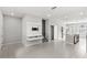 Open concept living space with tile flooring, island, tv entertainment center, and stairs at 5006 Caspian St, St Cloud, FL 34771