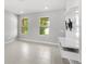 Open, bright living area with white tile flooring and built-in tv entertainment center at 5006 Caspian St, St Cloud, FL 34771