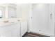 Modern bathroom featuring double sink vanity, sleek mirror, and spacious walk-in shower with white tile at 5217 Marshelder St, Apopka, FL 32712
