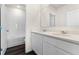 Elegant bathroom featuring double sink vanity, wood look flooring, and a shower tub combination at 5217 Marshelder St, Apopka, FL 32712