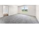 Bedroom with a window overlooking the outside, light-colored carpet, and neutral walls at 5217 Marshelder St, Apopka, FL 32712