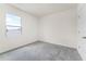 Bright bedroom featuring neutral walls, plush gray carpeting, and a window offering ample natural light at 5217 Marshelder St, Apopka, FL 32712