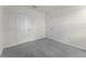 Neutral bedroom with plush gray carpet, featuring two white doors, base trim and neutral walls at 5217 Marshelder St, Apopka, FL 32712