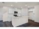 Bright kitchen featuring white cabinets, stainless steel appliances, and an island with bar seating at 5217 Marshelder St, Apopka, FL 32712