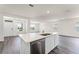 Kitchen island with stainless steel dishwasher and sink overlooks the living area at 5217 Marshelder St, Apopka, FL 32712