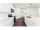 Stylish kitchen with white cabinets, modern stainless steel appliances, and a large island at 5217 Marshelder St, Apopka, FL 32712