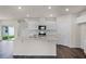 Modern kitchen with white cabinets, stainless steel appliances, and a central island at 5217 Marshelder St, Apopka, FL 32712