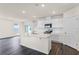 Bright kitchen with white cabinets, stainless steel appliances, and a large center island at 5217 Marshelder St, Apopka, FL 32712
