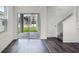 Living room with sliding glass doors to the back yard and dark wood-look flooring at 5217 Marshelder St, Apopka, FL 32712