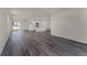 Spacious living area and kitchen with an open-concept design, modern flooring, and bright natural light at 5217 Marshelder St, Apopka, FL 32712