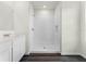 Contemporary bathroom boasts a white shower stall, streamlined vanity, and stylish flooring at 5217 Marshelder St, Apopka, FL 32712