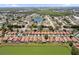 An expansive aerial shot featuring residences near a serene pond and lush greenery at 5337 Watervista Dr, Orlando, FL 32821