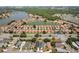 Expansive aerial view of a community with waterfront homes, lush trees, and orange rooftops near a picturesque lake at 5337 Watervista Dr, Orlando, FL 32821