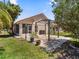 Beautiful backyard featuring a paver patio with pergola, mature trees, and a screened in lanai at 5337 Watervista Dr, Orlando, FL 32821