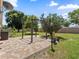 Inviting backyard features a paver patio with pergola, a lush lawn, and mature trees for shade at 5337 Watervista Dr, Orlando, FL 32821