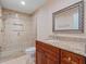 Bathroom with granite countertop, framed mirror and glass enclosed tiled shower at 5337 Watervista Dr, Orlando, FL 32821