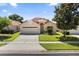 Lovely single-story home with a well-maintained lawn, mature tree, and an attached two-car garage at 5337 Watervista Dr, Orlando, FL 32821