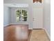 Bright foyer featuring wood floors, white walls, and a decorative window above the front door at 5337 Watervista Dr, Orlando, FL 32821