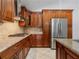 Kitchen features stainless steel appliances, granite counters, and brown cabinets at 5337 Watervista Dr, Orlando, FL 32821