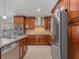 Kitchen features stainless steel appliances, granite counters, and brown cabinets at 5337 Watervista Dr, Orlando, FL 32821