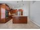 Kitchen features a large center island, stainless steel appliances, and brown cabinets at 5337 Watervista Dr, Orlando, FL 32821