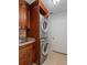 Laundry room with stackable washer and dryer and brown cabinets at 5337 Watervista Dr, Orlando, FL 32821
