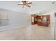 Living room area with travertine tile floors open to kitchen at 5337 Watervista Dr, Orlando, FL 32821