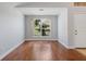 Empty living room showcasing hardwood floors, white walls, and a window for natural light at 5337 Watervista Dr, Orlando, FL 32821