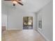 Bright living room featuring tile floors, ceiling fan, and sliding glass doors to the outside at 5337 Watervista Dr, Orlando, FL 32821