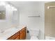 Bathroom with a double sink, wood cabinets, toilet, tub, and tiled shower at 6095 Village Cir # 6095, Orlando, FL 32822