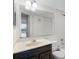 Bathroom features a dark wood cabinet, mirror, and a tub with shower at 6095 Village Cir # 6095, Orlando, FL 32822