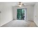 Bright bedroom with carpet and sliding glass door to a small balcony at 6095 Village Cir # 6095, Orlando, FL 32822