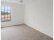 A bright and spacious bedroom with carpet and a large window at 6095 Village Cir # 6095, Orlando, FL 32822