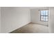 A bedroom with carpet and a single window at 6095 Village Cir # 6095, Orlando, FL 32822