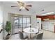 Dining room and kitchen area with white appliances and a marble-top table at 6095 Village Cir # 6095, Orlando, FL 32822