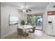 Dining area leading to a balcony, complemented by tile flooring at 6095 Village Cir # 6095, Orlando, FL 32822
