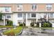 Two story condo building featuring guest parking, with easy access to units and decorative landscaping at 6095 Village Cir # 6095, Orlando, FL 32822