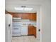 Cozy kitchen featuring white appliances and plenty of cabinet storage at 6095 Village Cir # 6095, Orlando, FL 32822