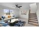 Bright living room featuring tile floors, a ceiling fan, and staircase access at 6095 Village Cir # 6095, Orlando, FL 32822