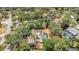 Aerial view of homes with pools in a tree-lined neighborhood, offering a serene and private living environment at 702 N Sweetwater Blvd, Longwood, FL 32779