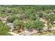 Aerial view of a property surrounded by lush trees in a residential neighborhood at 702 N Sweetwater Blvd, Longwood, FL 32779