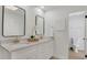 Elegant bathroom with double sinks, quartz countertop, and modern fixtures at 702 N Sweetwater Blvd, Longwood, FL 32779