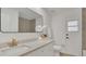 Elegant bathroom featuring a marble countertop, modern fixtures, and a decorative mirror at 702 N Sweetwater Blvd, Longwood, FL 32779